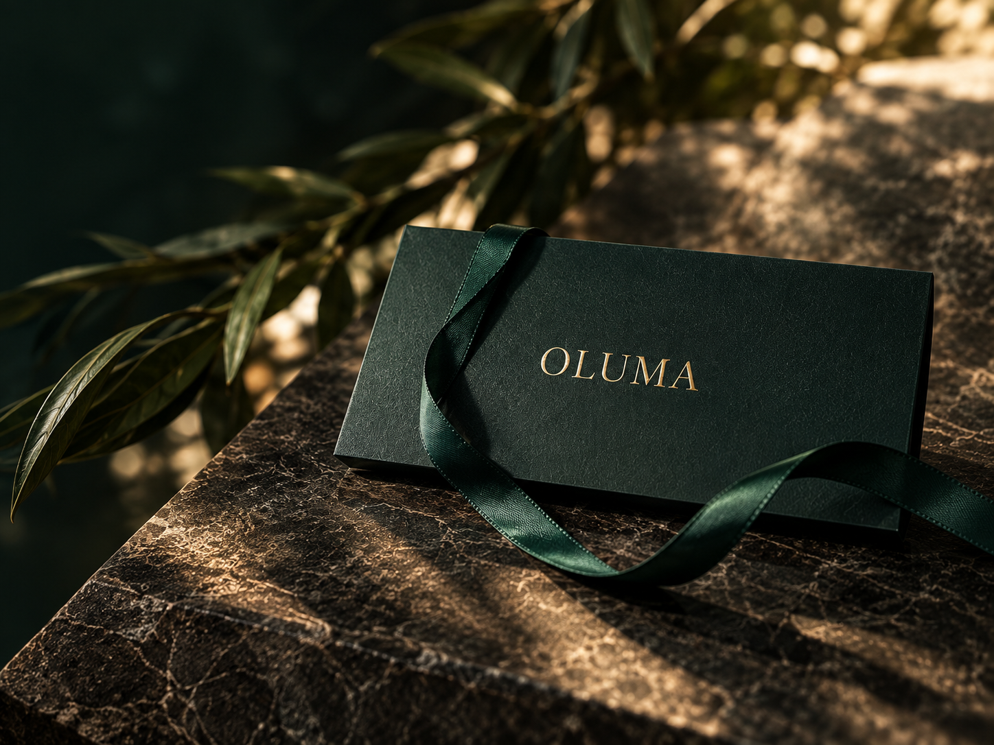 Forest green OLUMA gift card with a satin ribbon